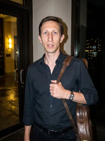 Peter, AI character: outside the hotel bar entrance late on a humid Thursday night in Chicago, after his piano set, with dark…