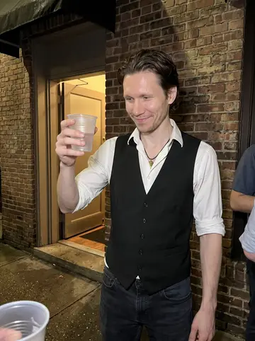 Donovan, AI character: outside the bar after closing on a humid Savannah night, coworkers gathered just out of frame near the…