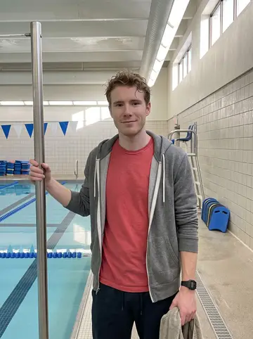 Mason, AI character: inside the community Y pool area in Columbus just after early laps, leaning on the metal railing beside…