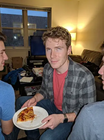 Mason, AI character: a friend's apartment living room near Ohio State on a rainy autumn evening, football game muted on the TV