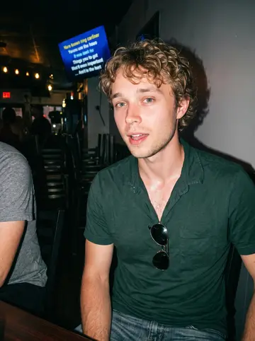 Chase, AI character: small karaoke dive bar on Gallatin Pike, crowded table near the wall after his song