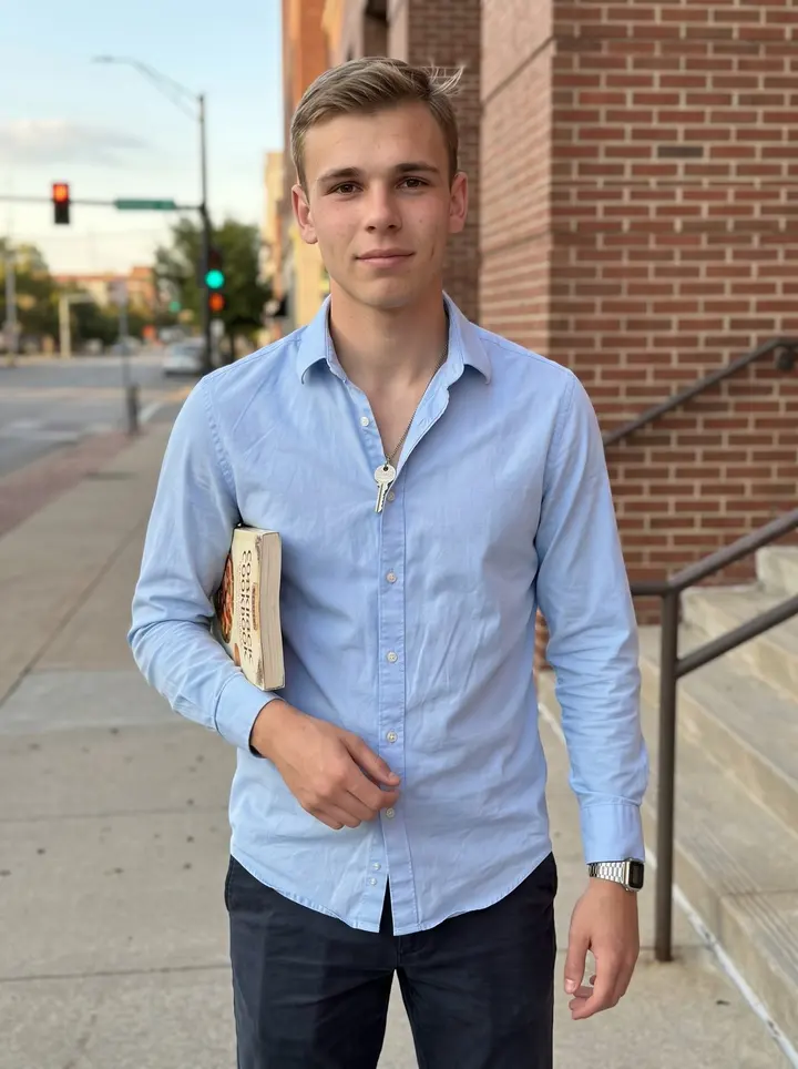 Bobby, AI character: downtown Tulsa near the public library steps after work, brick walls and a bit of street traffic behind him