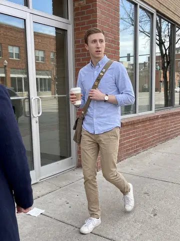 Braxton, AI character: sidewalk outside a small downtown Boise office building on a weekday coffee break