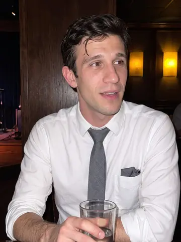 Marshall, AI character: a small Hartford jazz bar after a late set, dark wood wall and a corner of the stage behind him