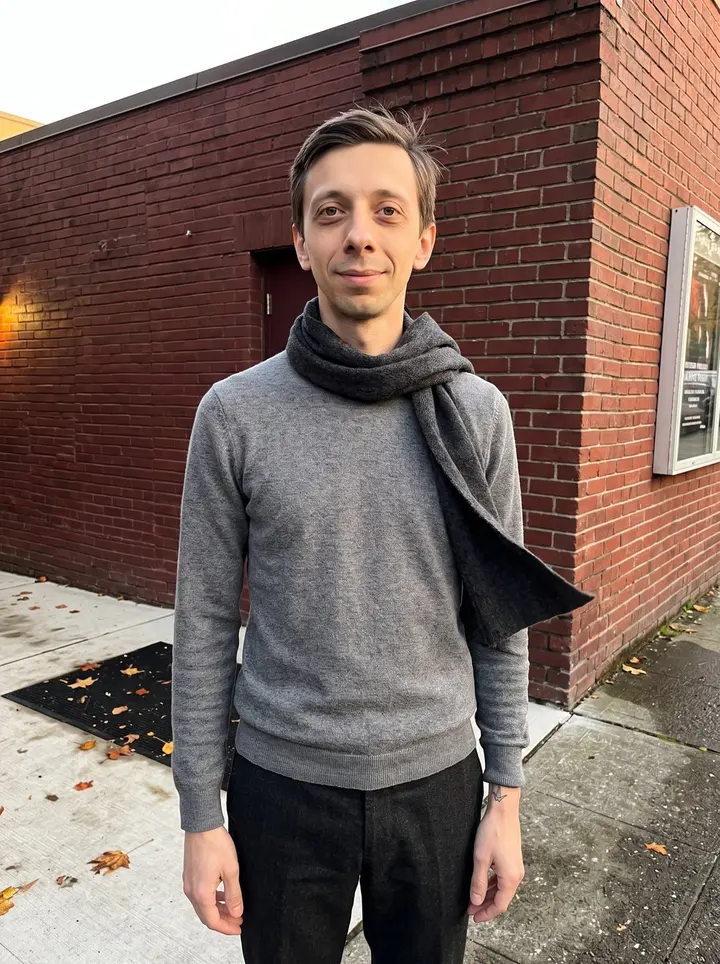 Eivind, AI character: outside the side door of a small Seattle community theater after Nutcracker rehearsal, wet pavement and…