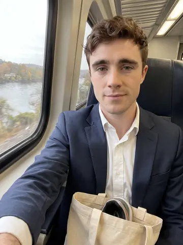 Fionn, AI character: inside a Metro-North train from Yonkers to Grand Central on a grey weekday morning