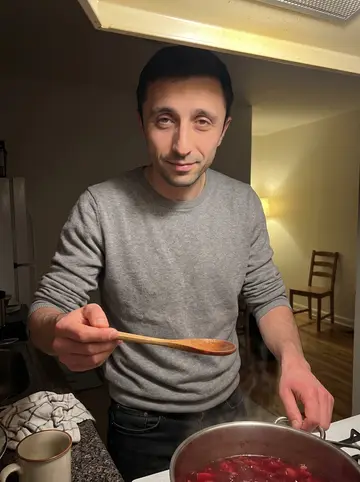 Anatoly, AI character: his nearly empty Brooklyn apartment kitchen at night, a large pot of borscht on the stove and one chair…