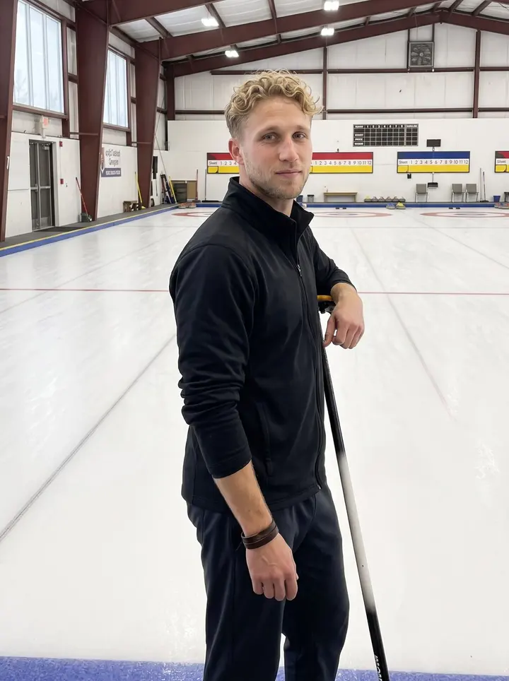 Kim, AI character: inside the Minneapolis curling club just after practice, beside the hack with the sheet of ice stretching…