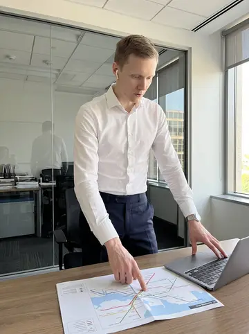 Mikael, AI character: his shipping brokerage office, standing beside a glass conference-room wall with a port schedule on a…