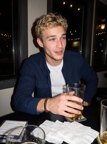 Mathias, AI character: a small Ballard neighborhood bar after work, trivia cards and pint glasses on the table, dark windows behind