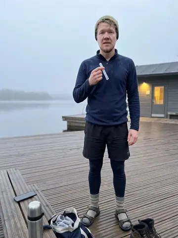 Lauri, AI character: the wooden deck beside the Tampere lake at 6 a