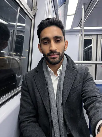Yash, AI character: a PATH train window seat between Jersey City and Manhattan after a late filing