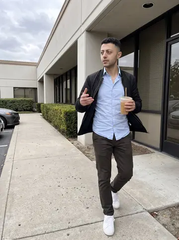 Mehdi, AI character: outside a low office building in Irvine during a late lunch break, concrete walkway and trimmed hedges…