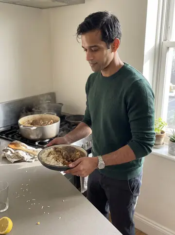 Umar, AI character: his apartment kitchen on a Sunday morning, a large pot of lamb shoulder and rice on the stove