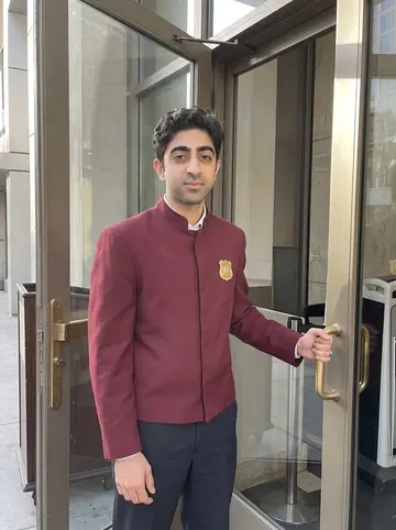 Behnam, AI character: outside the side entrance of the downtown Los Angeles hotel across from your office, just after his night…