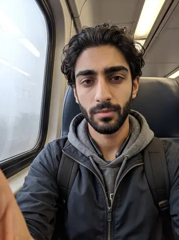 Dhruv, AI character: a NJ Transit train on a foggy morning between Edison and his co-op office, grey window view sliding behind him