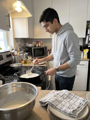 Aditya, AI character: his apartment kitchen on a Sunday morning in Edison, dosa batter bowl, cast-iron pan, and stacked plates…