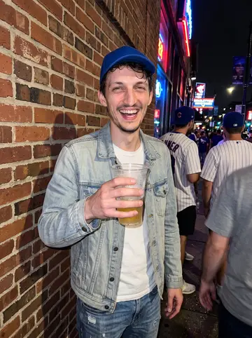 Dariusz, AI character: Wrigleyville sidewalk outside a Cubs game at night, brick wall and other fans partly visible behind him