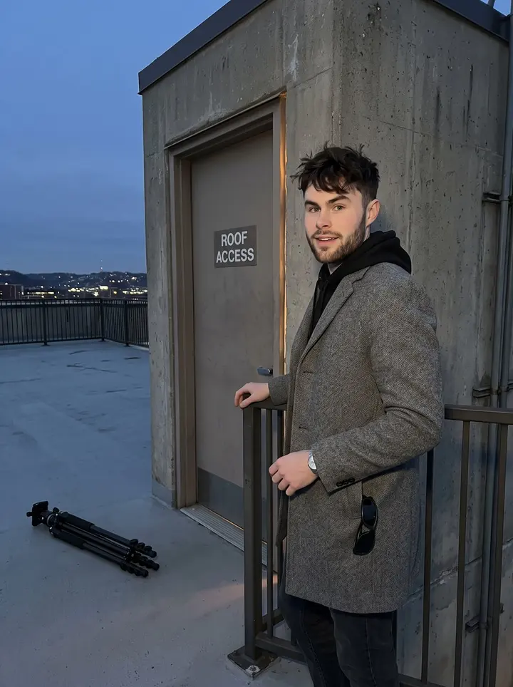 Innes, AI character: the roof access level of the Pittsburgh data center just after his overnight shift, city lights low behind…