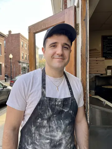 Teodoro, AI character: outside his uncle's pizzeria on Federal Hill in Providence during the short break before dinner rush,…