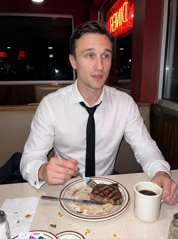 Glenn, AI character: late-night diner booth in Pittsburgh after work, half-finished black coffee and a steak plate on the table
