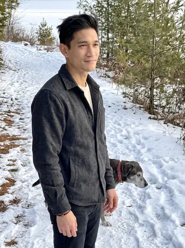 Eric, AI character: a packed snowy trail near Presque Isle Park in Marquette, Lake Superior bright behind the pines, Pickle…