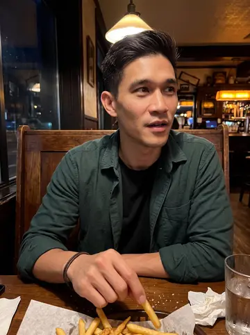 Eric, AI character: a small Marquette tavern after a late clinic shift, wood booth, half-empty basket of fries, dark window…